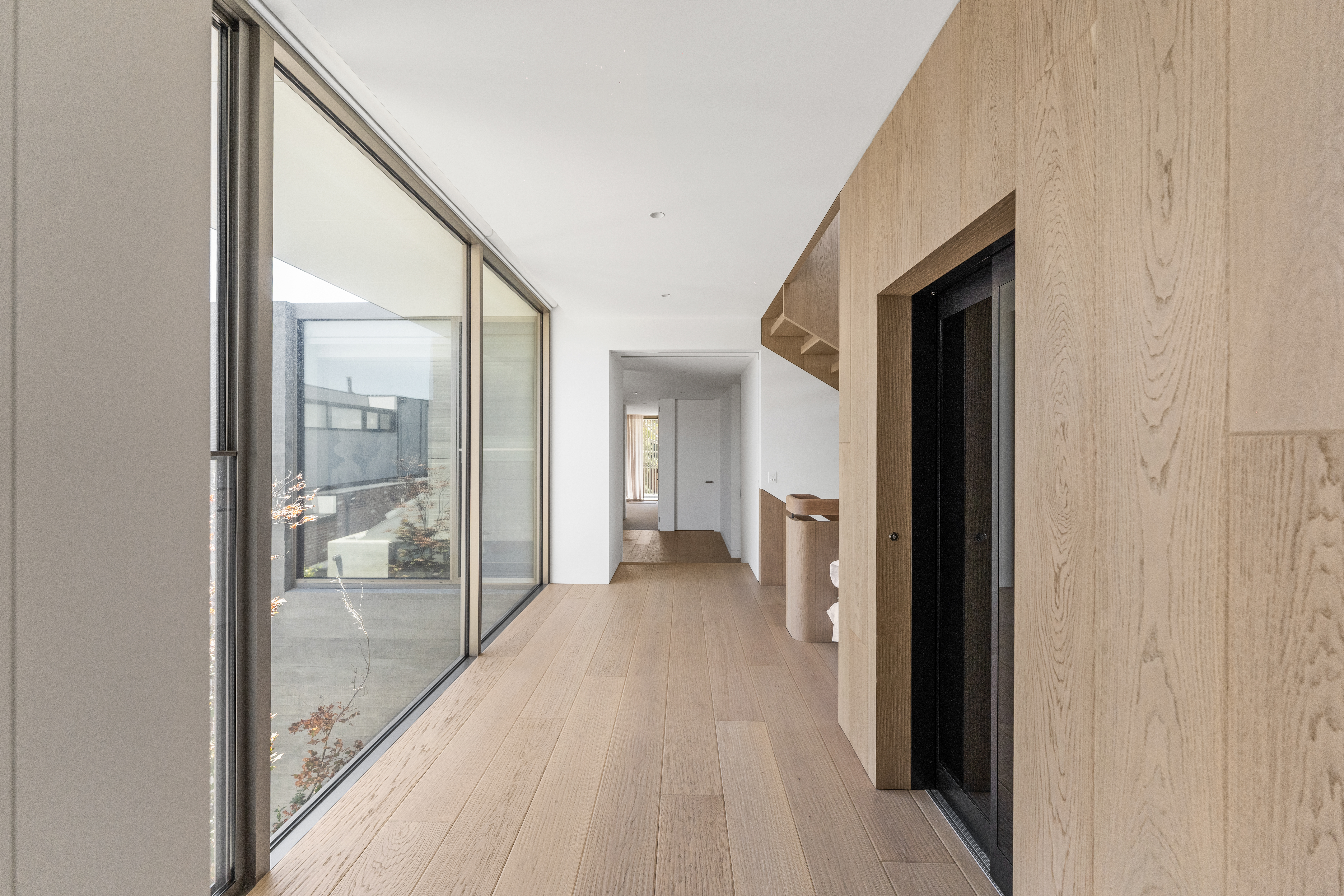 Timber-lined corridor with natural light